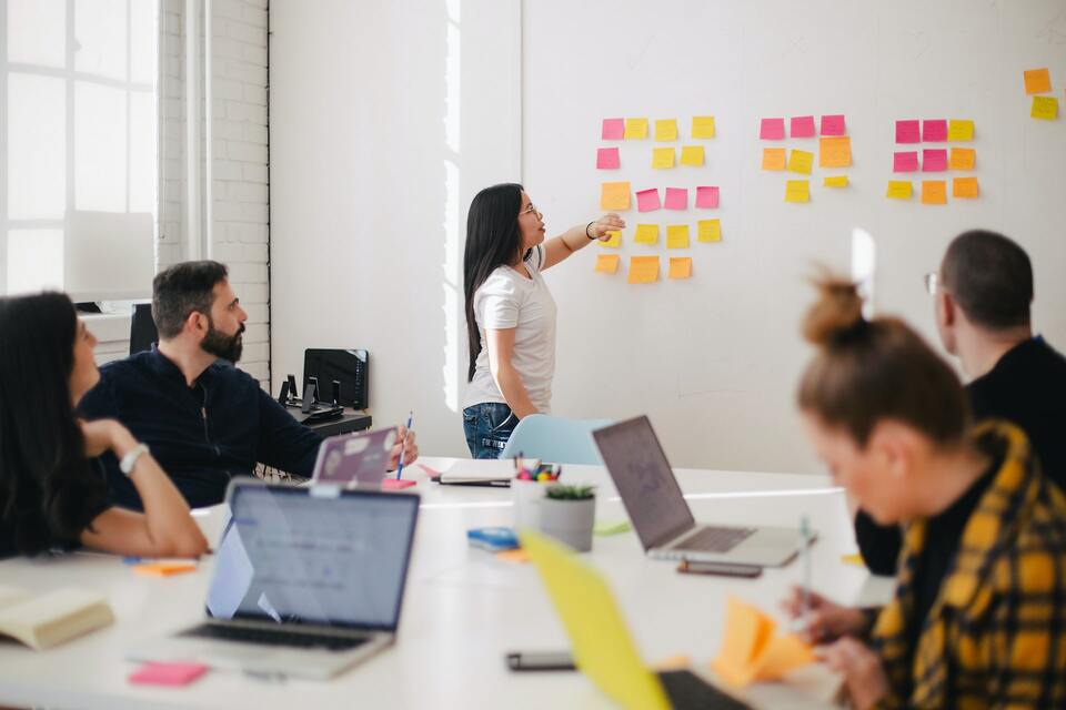 Trainer points at whiteboard in intercultural course